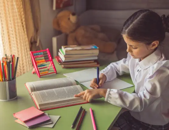 student sitting at a desk focused and completing homework