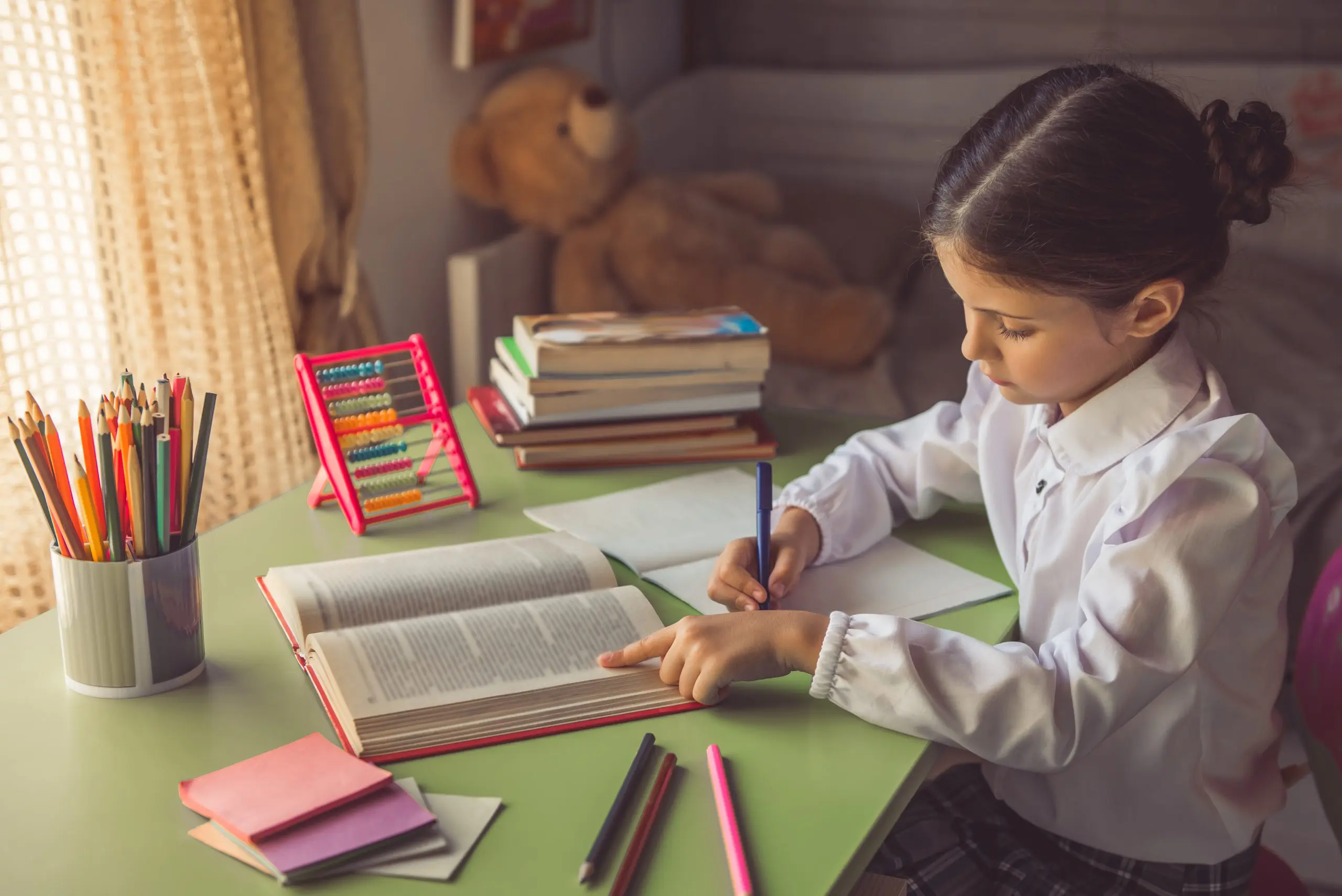 student sitting at a desk focused and completing homework