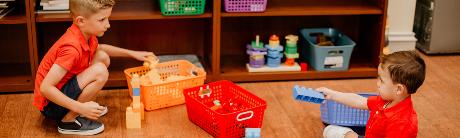 two young boys play with colorful blocks in the Austin's Playroom at the Watson Institute