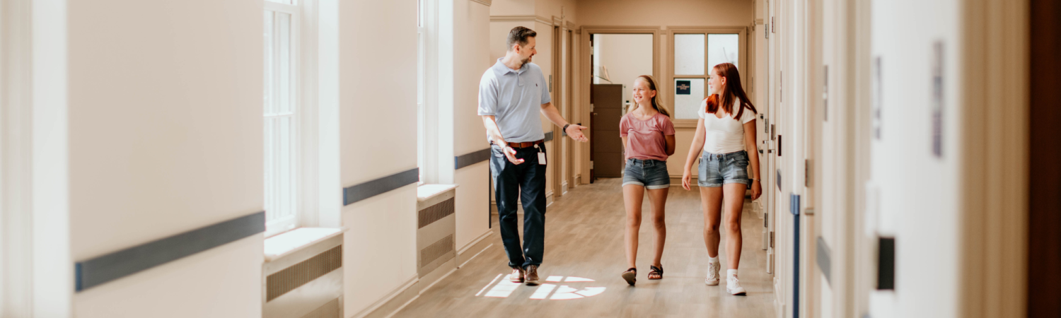 therapist walking down the hallway with two young adolescent women