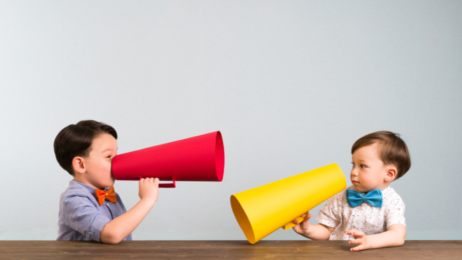 two children pictured with colorful megaphones in hand