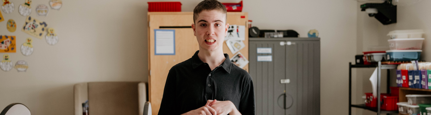 young student with special needs smiling in his classroom setting