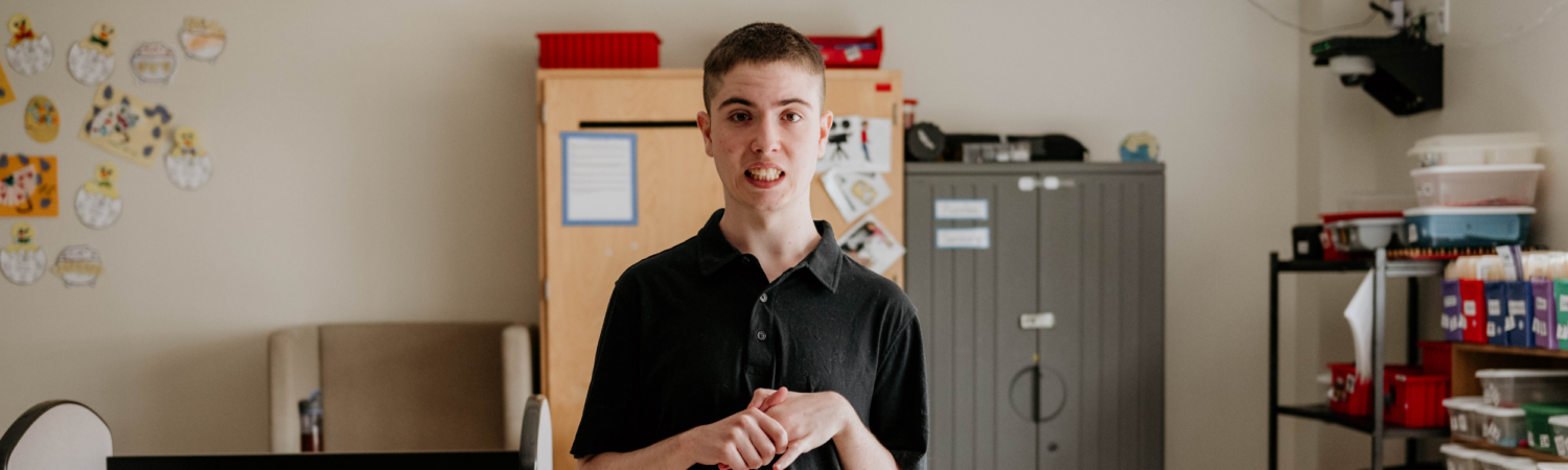 young student with special needs smiling in his classroom setting